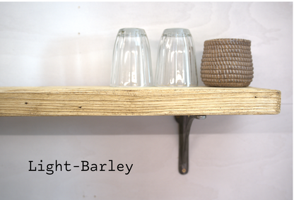 A light-barley stained wooden floating shelf mounted on a white wall, holding two clear drinking glasses and a woven basket, with the text 'Light-Barley' overlaid at the bottom left.