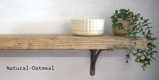 A rustic wooden shelf mounted on a white wall, with a cream-colored ribbed bowl on top and a green trailing plant in a woven pot. The text 'Natural-Oatmeal' is displayed in the lower-left corner.